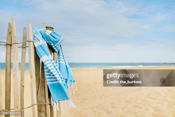 blanket hanging at fence at beach - draped blanket stock pictures, royalty-free photos & images