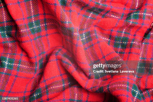 close up of knitted red, black and green diagonal plaid scottish seamless pattern. christmas and new year concept. - kilt stock-fotos und bilder