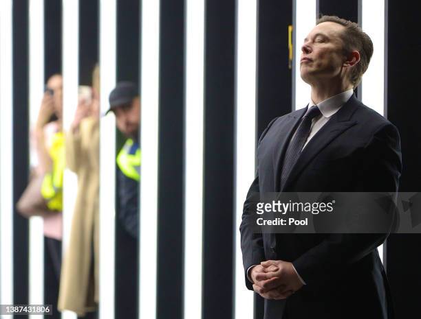 Tesla CEO Elon Musk contemplates during the official opening of the new Tesla electric car manufacturing plant on March 22, 2022 near Gruenheide,...