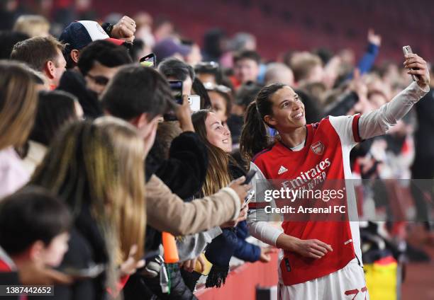 Tobin Heath of Arsenal takes a selfie with fans at full-time after the UEFA Women's Champions League Quarter Final First Leg match between Arsenal...