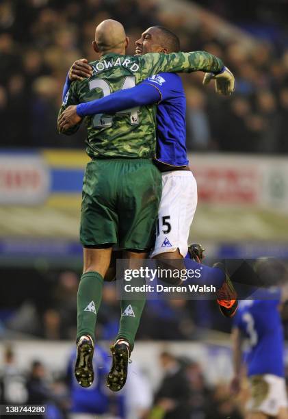 Tim Howard of Everton celebrates with Sylvain Distin at the end of the Barclays Premier League match between Everton and Chelsea at Goodison Park on...