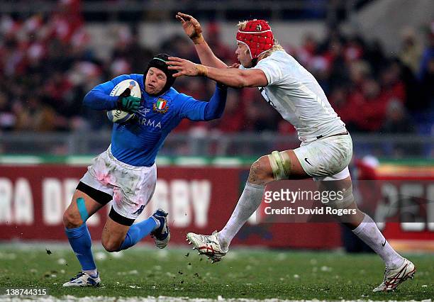 Flyhalf Kristopher Burton of Italy is tackled by Mouritz Botha of England during the Six Nations match between Italy and England at Stadio Olimpico...