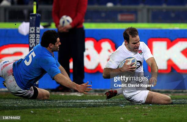 Flyhalf Charlie Hodgson of England slides past Andrea Masi of Italy to scor ehis team's first try during the Six Nations match between Italy and...