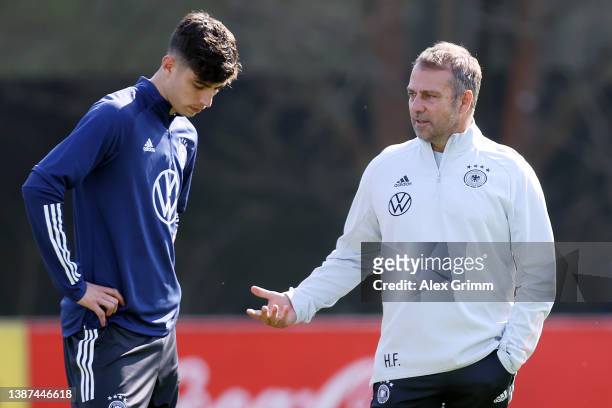 Head coach Hans-Dieter Flick talks to Kai Havertz during a training session of Germany at the Eintracht Frankfurt training ground on March 24, 2022...
