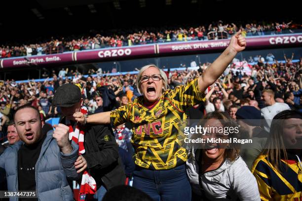 An Arsenal fan celebrates after the final whistle during the Premier League match between Aston Villa and Arsenal at Villa Park on March 19, 2022 in...