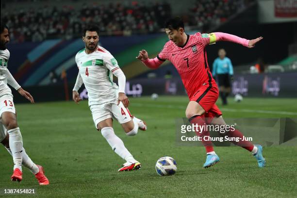 Son Heung-Min of South Korea competes for the ball with Shojae Khalilzadeh of Iran during the FIFA World Cup Asian Qualifier Final Round Group A...
