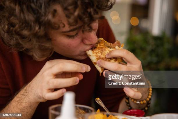 young boy enjoying eating a taco - burrito 個照片及圖片檔