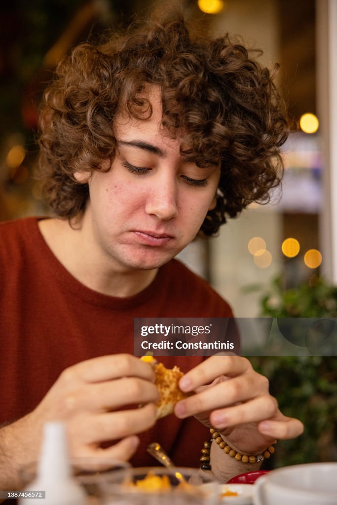 Young boy eating a burrito