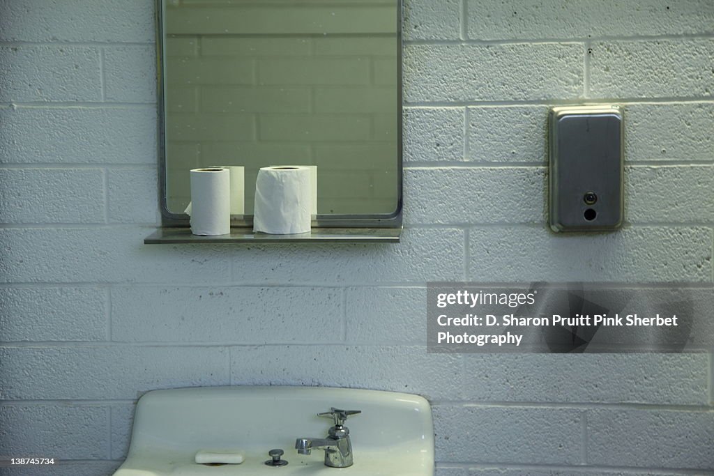 Restroom sink, mirror and rolls