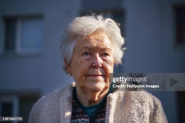 close-up of sad senior woman walking in city. - smart cities stockfoto's en -beelden