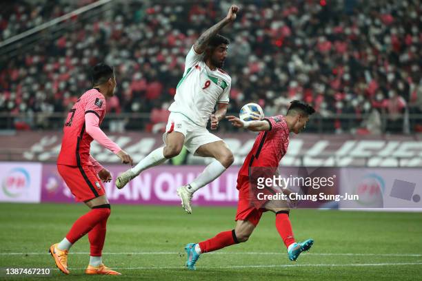 Allahyar Sayyadmanesh of Iran competes for the ball with Kim Tae-Hwan of South Korea during the FIFA World Cup Asian Qualifier Final Round Group A...