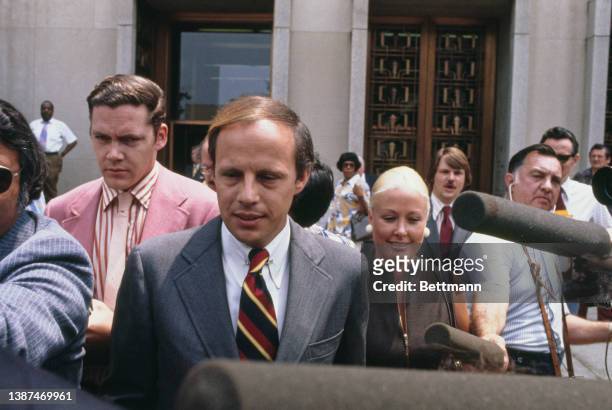 American lawyer John Dean, who who served as White House Counsel for US President Nixon, accompanied by his wife, Maureen, as he departs after...