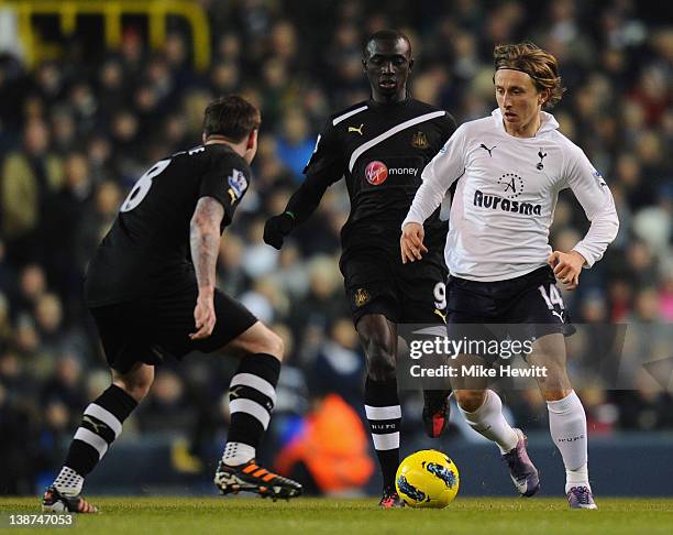 Luka Modric of Spurs is closed down by Papiss Demba Cisse and Danny Guthrie of Newcastle United during the Barclays Premier League match between...