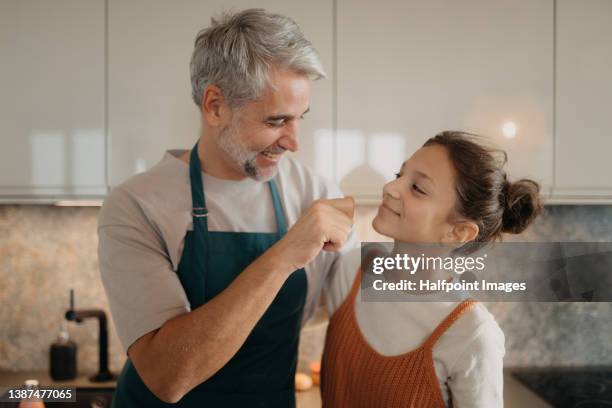 teenage girl with his father in kitchen together. - father daughter stock pictures, royalty-free photos & images