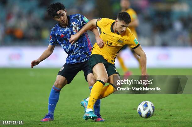 Takumi Minamino of Japan and Ajdin Hrustic of the Socceroos compete for the ball during the FIFA World Cup Qatar 2022 AFC Asian Qualifying match...