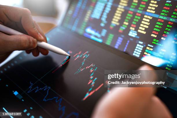 market analyze with digital monitor focus on tip of finger. - stock market and exchange stock pictures, royalty-free photos & images