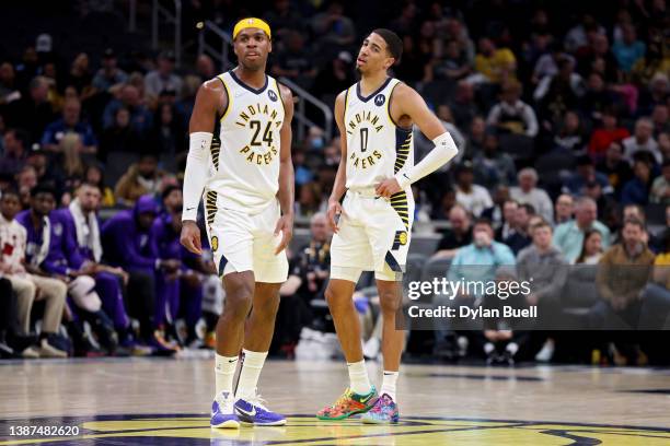 Buddy Hield and Tyrese Haliburton of the Indiana Pacers meet in the second quarter against the Sacramento Kings at Gainbridge Fieldhouse on March 23,...