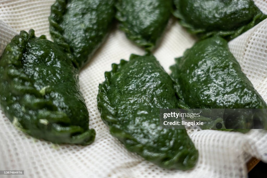 Chinese food, dumplings made with vegetable juice and noodles.