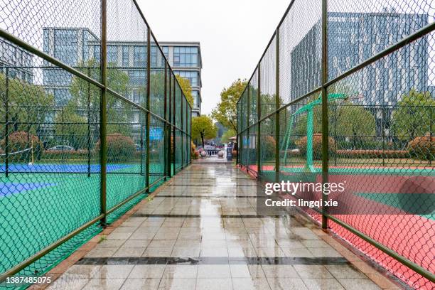 basketball court after rain - sports field fence stock pictures, royalty-free photos & images