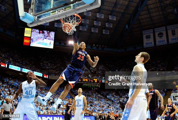 Harrison Barnes and Tyler Zeller of the North Carolina Tar Heels watch as Akil Mitchell of the Virginia Cavaliers dunks during play at the Dean Smith...