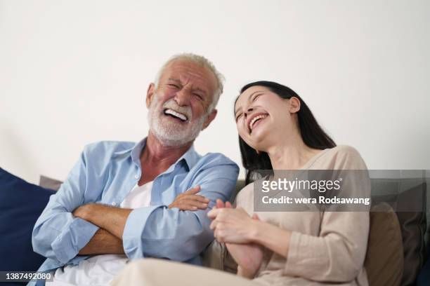daughter and aging father happy laughing together - tears of joy stock-fotos und bilder