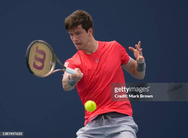 Aljaž Bedene of Slovenia returns a shot to Ugo Humbert of France during the 2022 Miami Open presented by Itaú at Hard Rock Stadium on March 24, 2022...