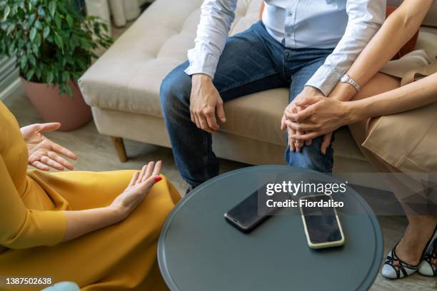 three business persons talking in the office - terapia de pareja fotografías e imágenes de stock