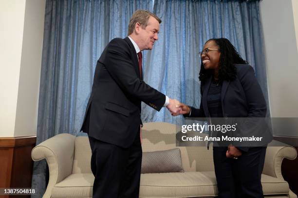 Supreme Court nominee Judge Ketanji Brown Jackson shakes Sen. Michael Bennet's hand before meeting in his office on March 24, 2022 in Washington, DC....