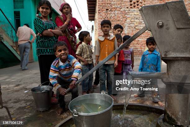 Young boy pumps water in the Kachhpur Village in Agra, India on March 5, 2012. The Kachhpur village is where people from the "Untouchable" class of...