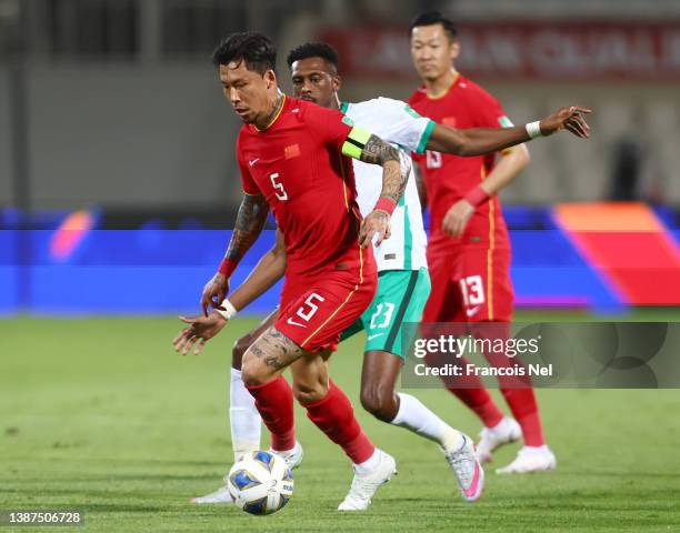 Zhang Linpeng of China controls the ball against Mohammed Kanno of Saudi Arabia during the FIFA World Cup Asian Qualifying match between China v...