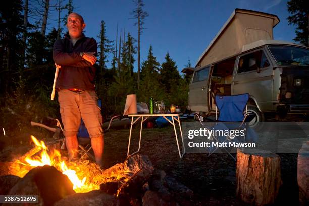 a senior man and his campfire vancouver island bc canada - carmanah walbran provincial park stock pictures, royalty-free photos & images