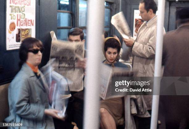 Passengers on the New York City subway with vintage ads in the background in January 1959 in New York City, New York.