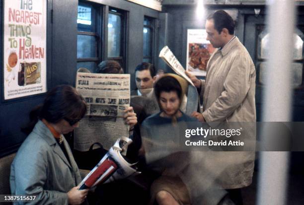 Passengers on the New York City subway with vintage ads in the background in January 1959 in New York City, New York.