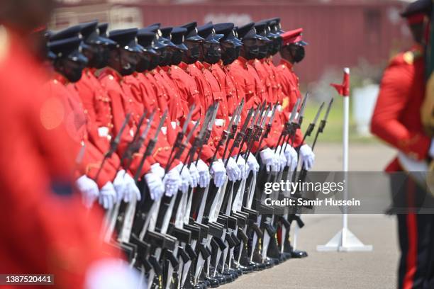 Soldiers stand guard ahead of the departure of Prince William, Duke of Cambridge and Catherine, Duchess of Cambridge from Norman Manley International...