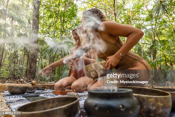 sound healing ceremony in the rainforest, two women - ceremony bildbanksfoton och bilder