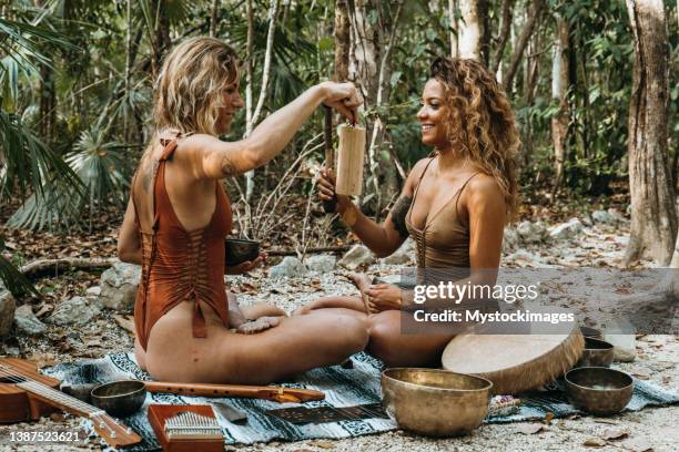 sound healing ceremony in the rainforest, two women playing music in nature - rin gong 個照片及圖片檔