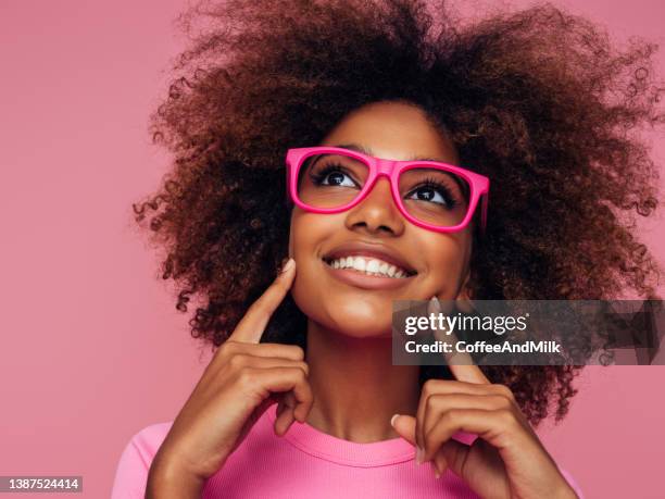 photo of young curly girl with glasses - choice student stockfoto's en -beelden