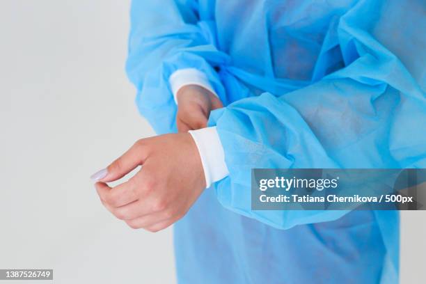 disposable medical uniform protects against viruses and bacteria - long sleeve stock pictures, royalty-free photos & images