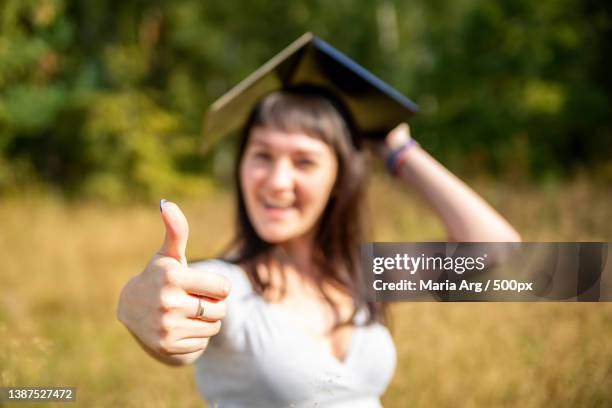online education concept thumb up in the background in blur young - class of 2020 sign stock pictures, royalty-free photos & images