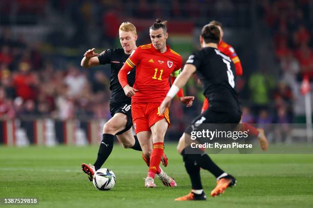 Gareth Bale of Wales is challenged by Nicolas Seiwald and Aleksandar Dragovic of Austria during the 2022 FIFA World Cup Qualifier knockout round...