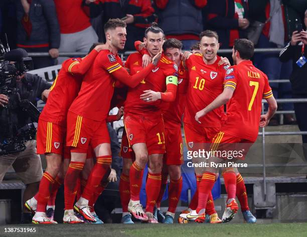 Gareth Bale of Wales celebrates with teammates after scoring their team's first goal from a free kick during the 2022 FIFA World Cup Qualifier...