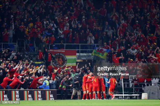 Gareth Bale of Wales celebrates with teammates in front of the Wales fans after scoring their team's second goal during the 2022 FIFA World Cup...