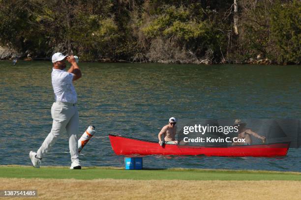 Spectators look on from a boat as Jon Rahm of Spain plays his shot from the 14th tee during the second day of the World Golf Championships-Dell...