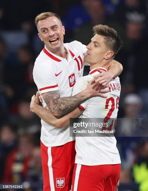Krzysztof Piatek of Poland celebrates after scoring their side's first goal with Kamil Grosicki during the international friendly match between...