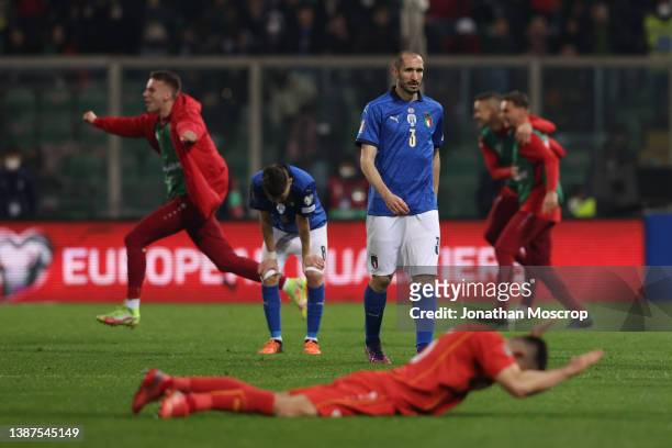 Giorgio Chiellini of Italy reacts as North Macedonia players celebrate at the final whistle of the 2022 FIFA World Cup Qualifier knockout round...