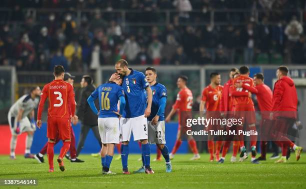 Alessandro Florenzi of Italy is consoled by team mate Giorgio Chiellini after the 2022 FIFA World Cup Qualifier knockout round play-off match between...