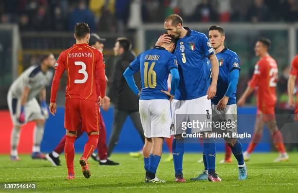 Alessandro Florenzi of Italy is consoled by team mate Giorgio Chiellini after the 2022 FIFA World Cup Qualifier knockout round play-off match between...