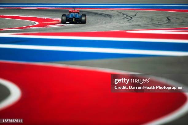 British McLaren Formula One racing team racing driver Jenson Button driving his MP4-28 racing car at speed through Turn Five of the circuit alongside...