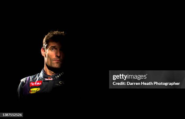 Portrait photograph of Australian Red Bull Racing Formula One racing team racing driver Mark Webber in highlights and shadows while wearing his logo...