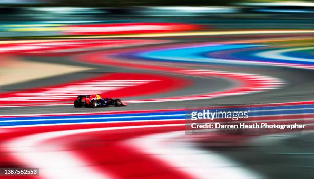 German Red Bull Racing Formula One racing team racing driver Sebastian Vettel driving his RB9 racing car at speed towards Turn Five of the circuit...